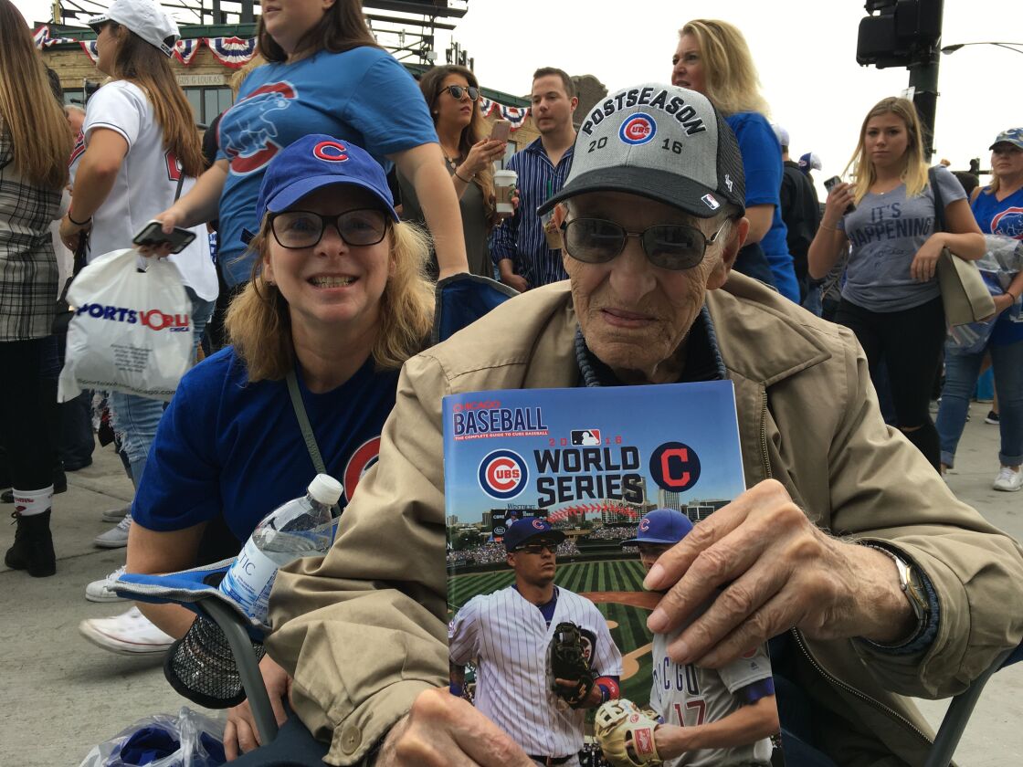Shirley Handley (left) and her father, Paul Cascio, wait outside the Wrigley Field Gates to watch the Cubs’ fourth World Series game against the Cleveland Indians. | Jacob Wittich/Sun-Times